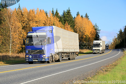 Image of Three Trucks Platooning on a Highway in Autumn