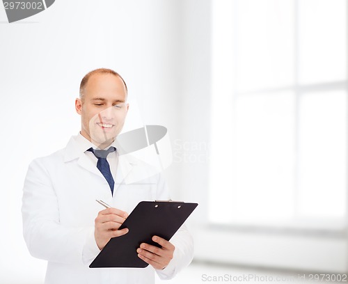 Image of smiling male doctor with clipboard