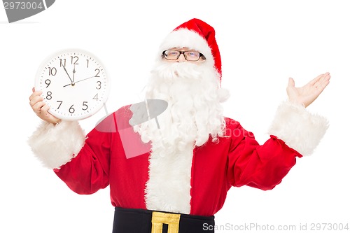 Image of man in costume of santa claus with clock