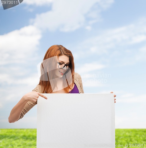 Image of smiling teenage girl in glasses with white board