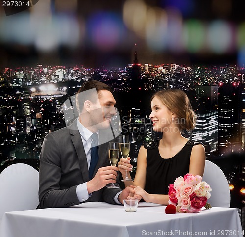 Image of couple with glasses of champagne at restaurant