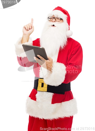 Image of man in costume of santa claus with tablet pc