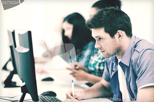 Image of student with computer studying at school