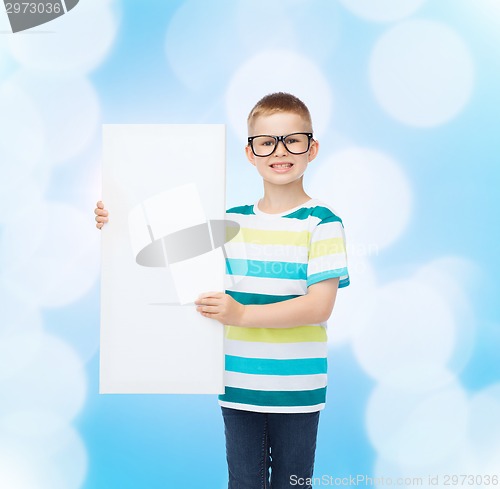 Image of smiling boy in eyeglasses with white blank board