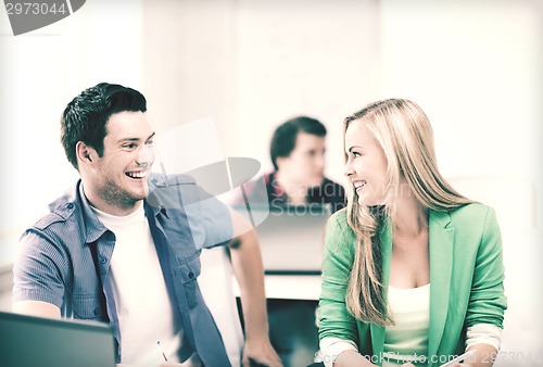 Image of smiling students looking at each other at school