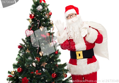 Image of santa claus with bag and christmas tree