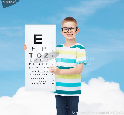 Image of smiling boy in eyeglasses with white blank board