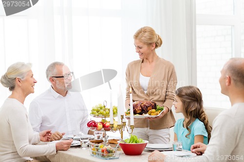 Image of smiling family having holiday dinner at home