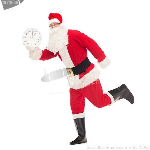 Image of man in costume of santa claus with clock