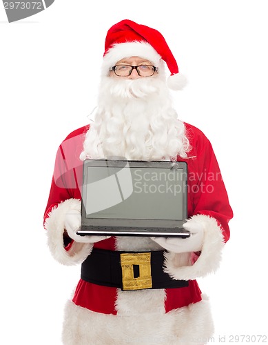 Image of man in costume of santa claus with laptop