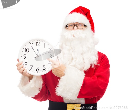 Image of man in costume of santa claus with clock