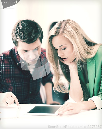 Image of students looking at tablet pc at school