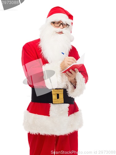 Image of man in costume of santa claus with notepad