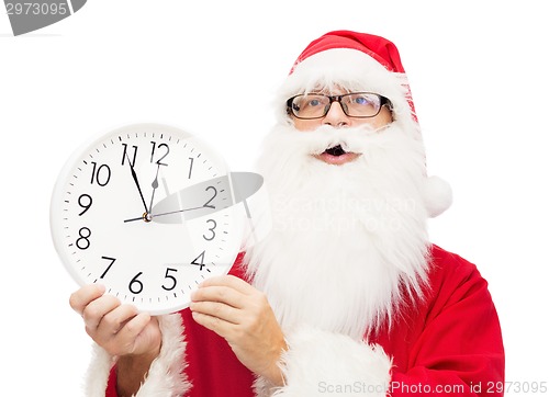 Image of man in costume of santa claus with clock