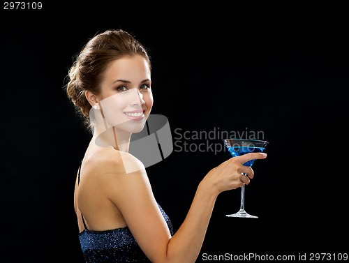 Image of smiling woman holding cocktail