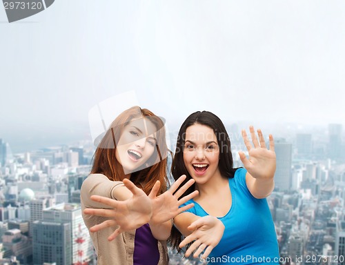 Image of smiling teenage girls having fun