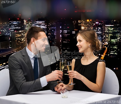 Image of couple with glasses of champagne at restaurant