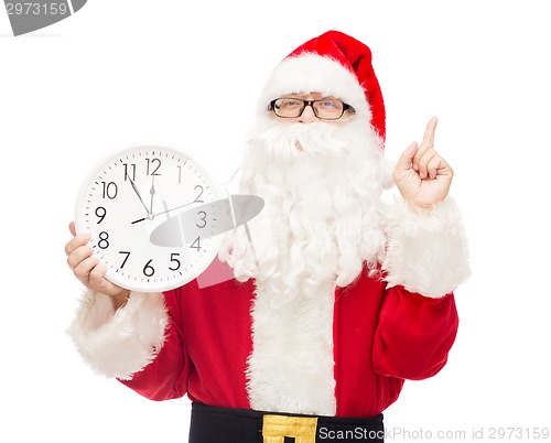 Image of man in costume of santa claus with clock