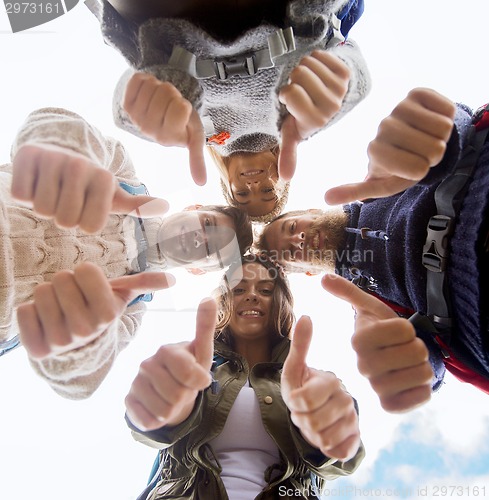 Image of group of smiling friends with backpacks hiking