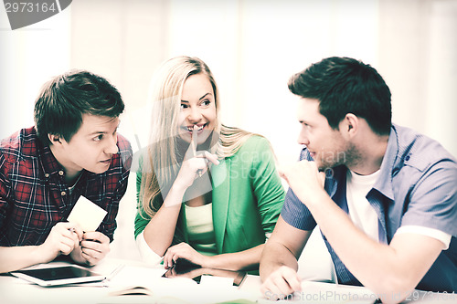 Image of group of students gossiping at school