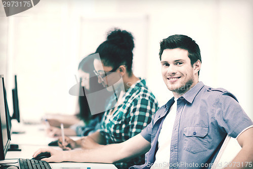 Image of student with computer studying at school