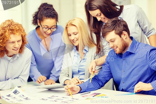 Image of smiling team with color samples at office