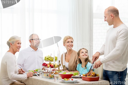 Image of smiling family having holiday dinner at home