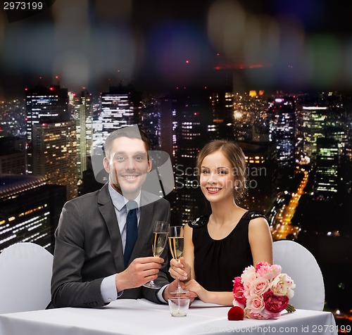 Image of couple with glasses of champagne at restaurant