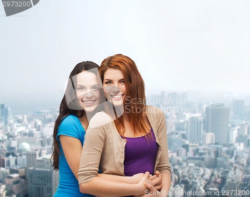 Image of smiling teenage girls hugging