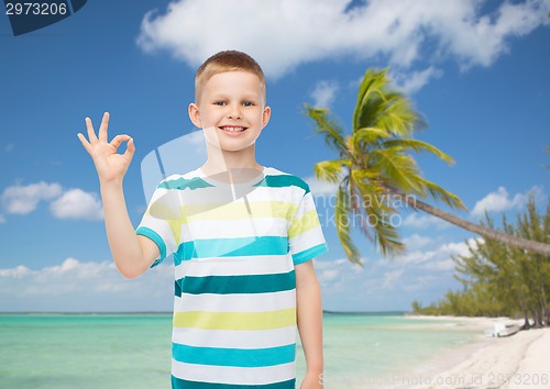 Image of little boy in casual clothes making ok sign