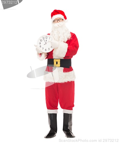 Image of man in costume of santa claus with clock