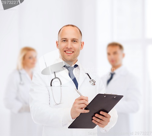 Image of smiling male doctor with clipboard and stethoscope