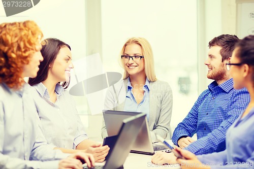 Image of smiling team with laptop and table pc computers