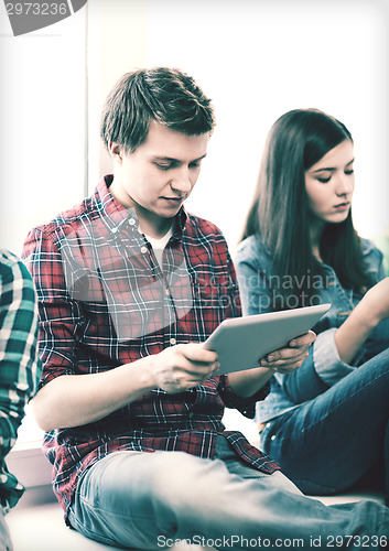 Image of student looking into tablet pc at school