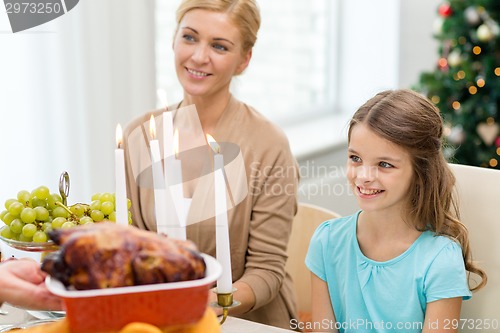 Image of smiling family having holiday dinner at home