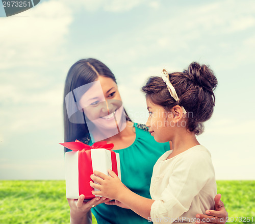 Image of happy mother and child girl with gift box