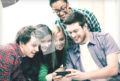 Image of students looking at smartphone at school