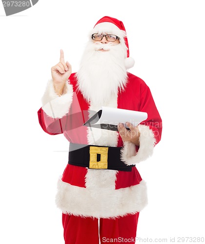 Image of man in costume of santa claus with notepad