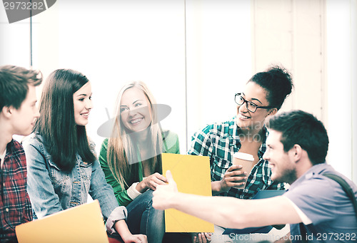 Image of students communicating and laughing at school