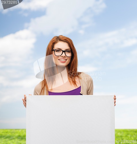 Image of smiling teenage girl in glasses with white board