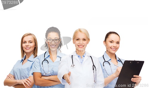 Image of smiling female doctor and nurses with stethoscope