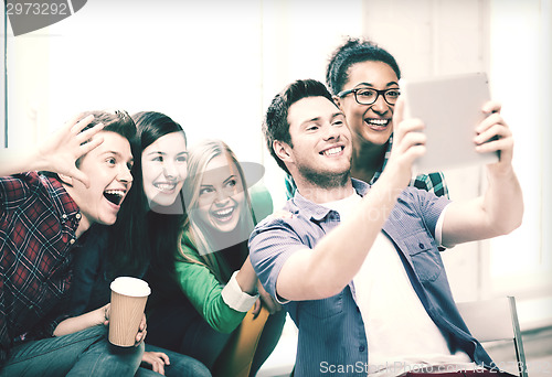 Image of students making picture with tablet pc at school