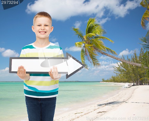 Image of smiling little boy with blank arrow pointing right