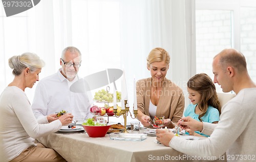 Image of smiling family having holiday dinner at home