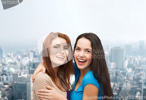 Image of smiling teenage girls hugging