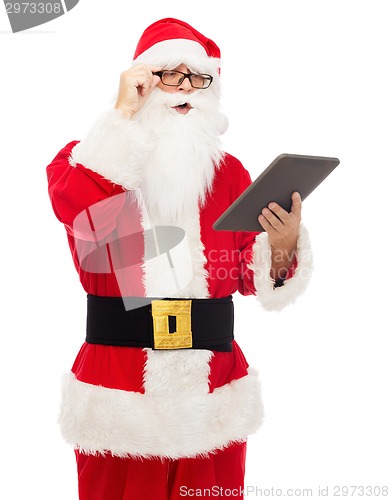 Image of man in costume of santa claus with tablet pc