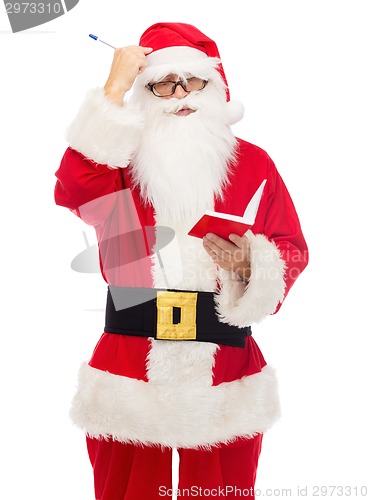 Image of man in costume of santa claus with notepad