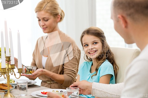 Image of smiling family having holiday dinner at home