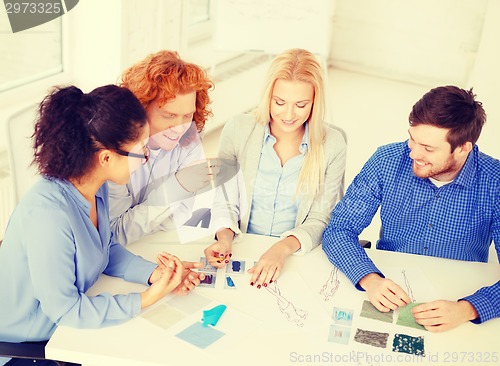 Image of smiling creative team looking at sketch