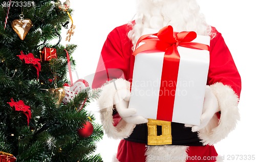 Image of man in costume of santa claus with gift box